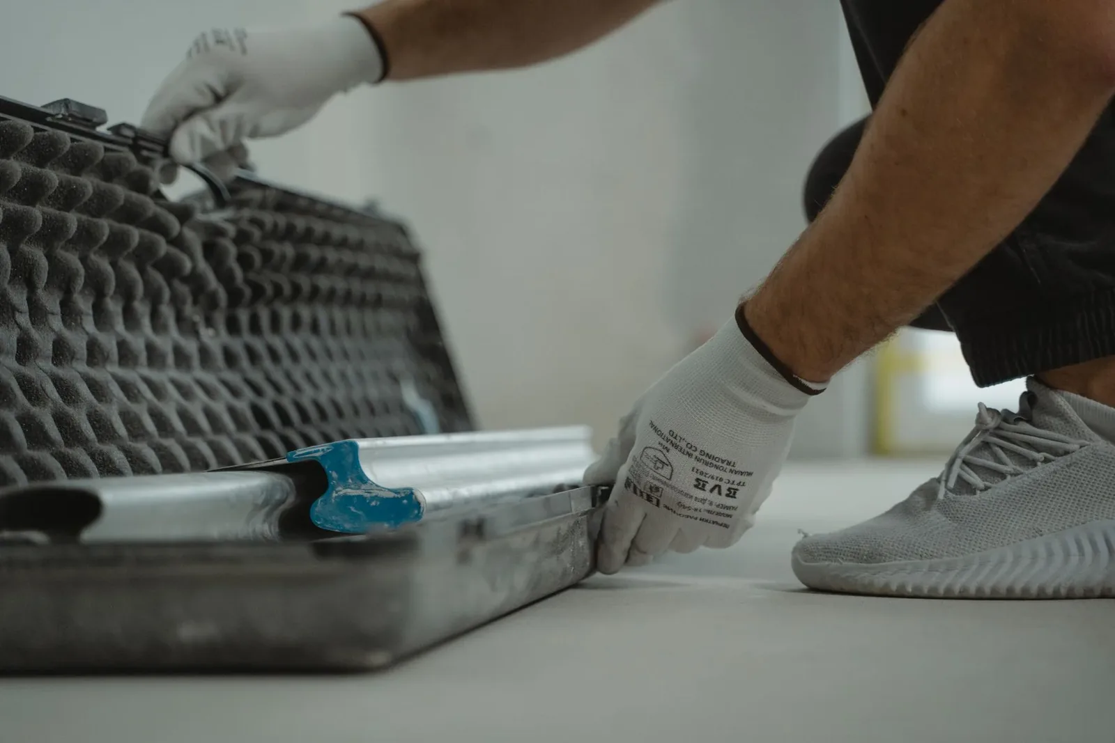 Gloved person checking protected tools before work begins